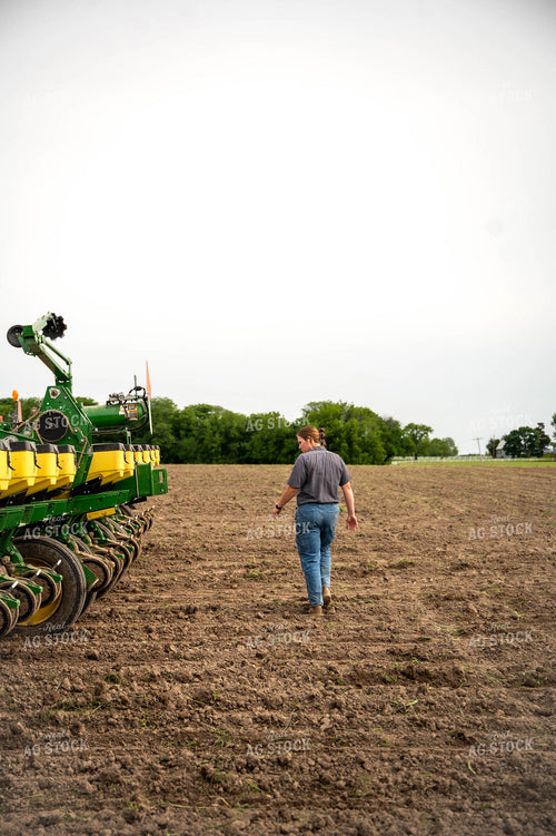 Female Farmer Walking by Planter 115655