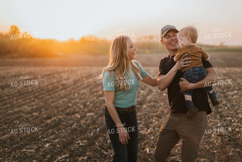Young Couple with Child in Field at Sunset 7720