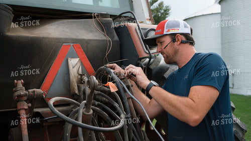 Farmer Fixing Tractor 26259