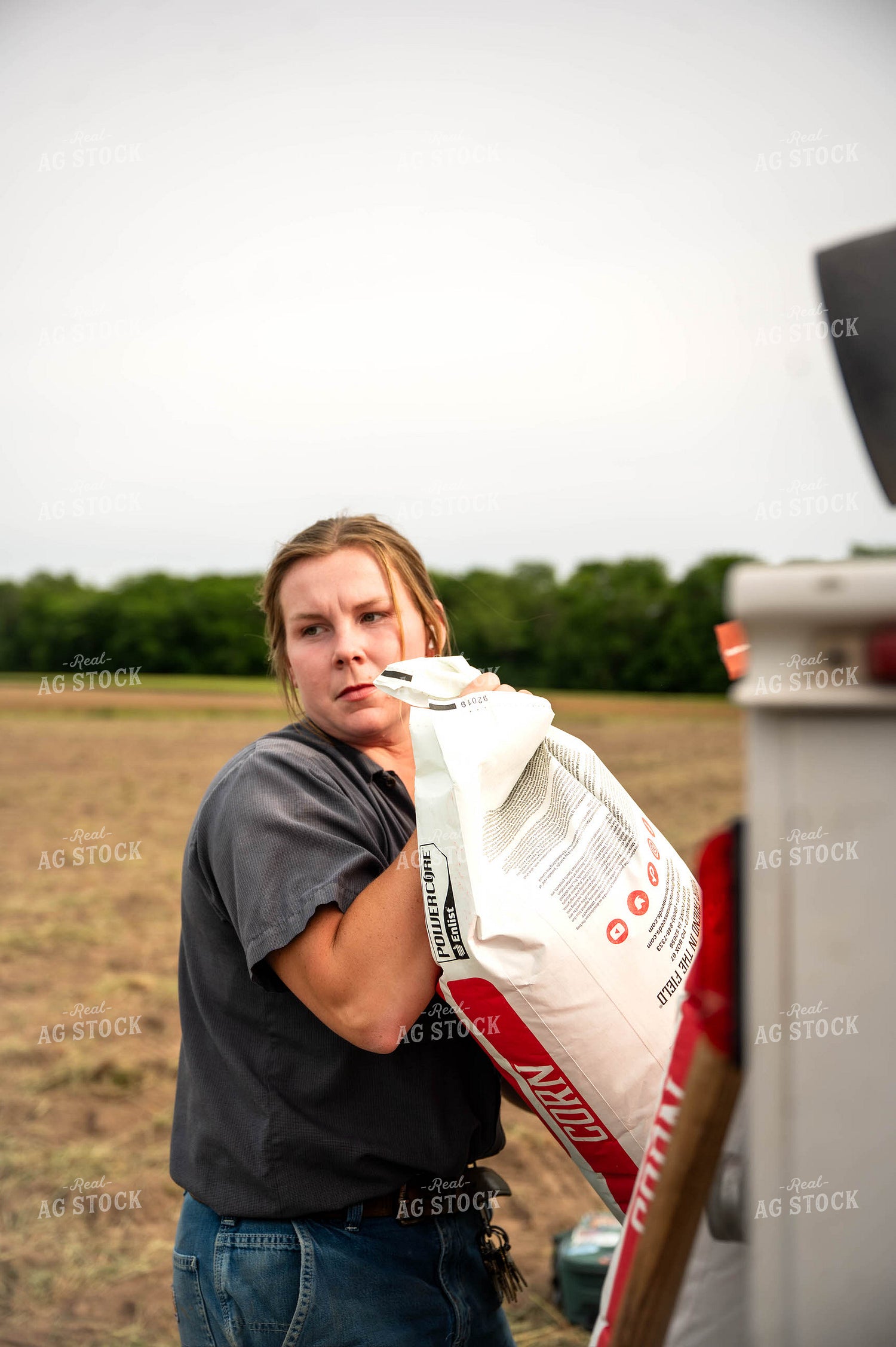 Female Farmer Filling Planter 115629