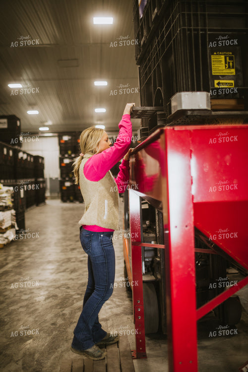 Forklift Operator Emptying Bulk Bin in Seed Warehouse 5350