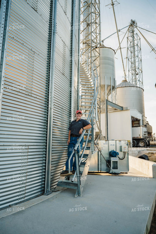 Female Farmer Climbing Grain Bin 115270