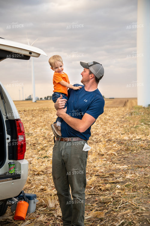 Father and Son Enjoying Harvest Meal in the Field 25824