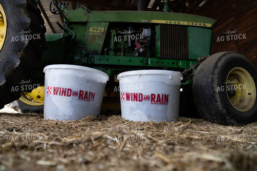 Rural Farming Supplies With Tractor and Cattle Mineral Buckets in Barn 65259