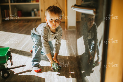 Farm Kid with Farm Equipment Toys in Kitchen 5000