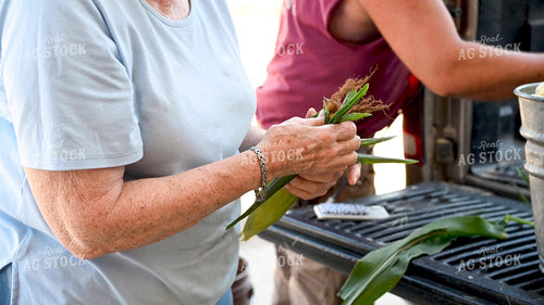 Family Shucking Sweet Corn 25250