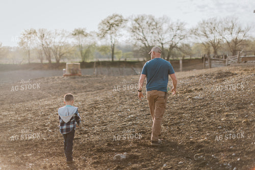 Farmer and Farm Kid Walking in Pasture 7391