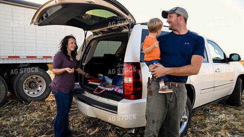 Family Enjoying Harvest Meal in the Field 25775