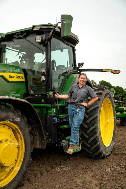 Female Farmer Climbing into Planter 115690