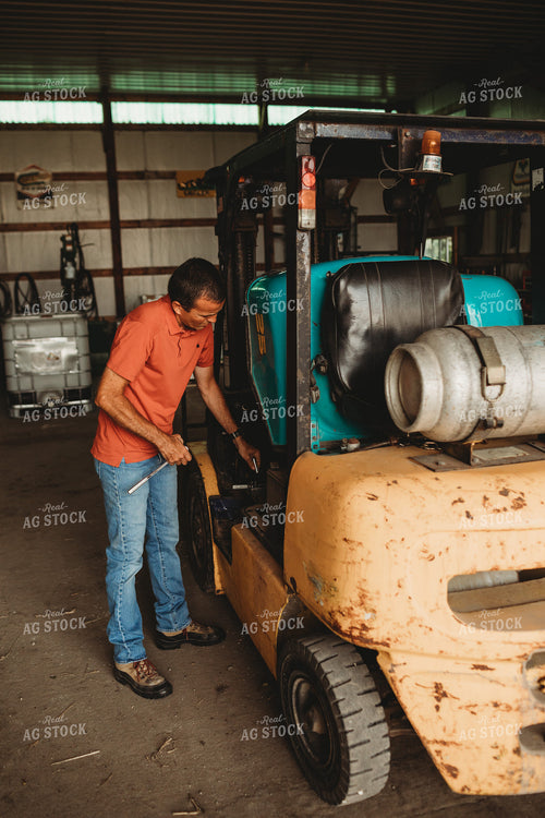 Farmer Working on Equipment 4514