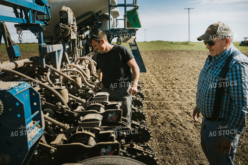 Farmers Adjusting Planter 4277