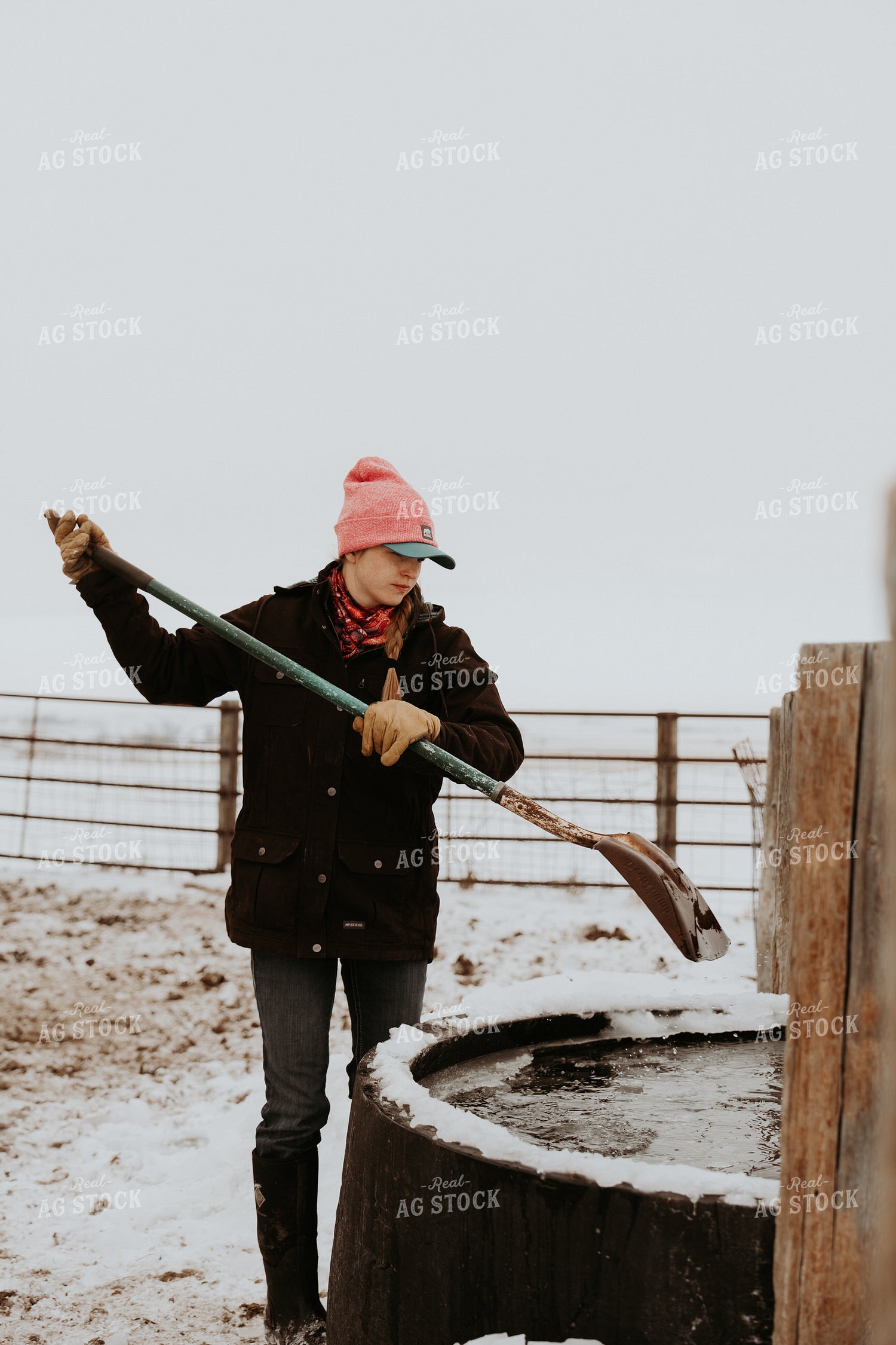 Female Rancher Breaking Up Water Trough 61179