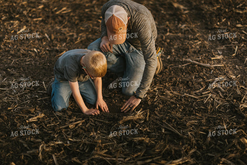 Farmer Checking Seed Depth with Son 8221