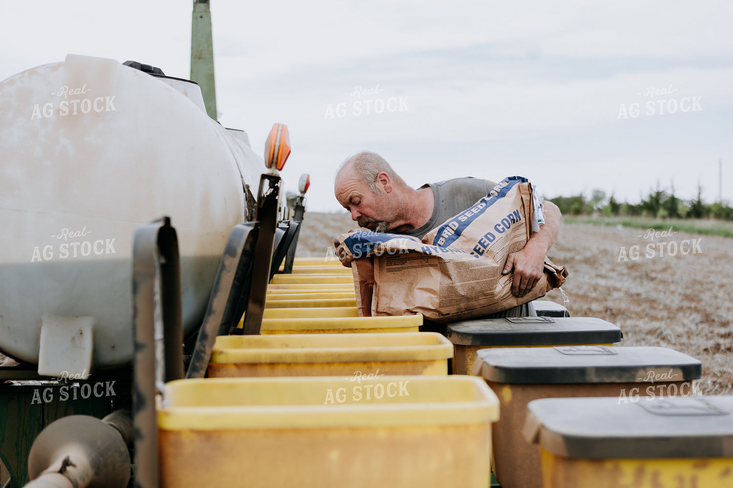 Farmer Filling Planter Boxes 77070