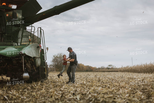 Farmer and Son Cimbing into Combine 8605