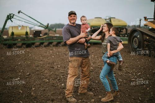 Farm Family in Field During Planting 5649