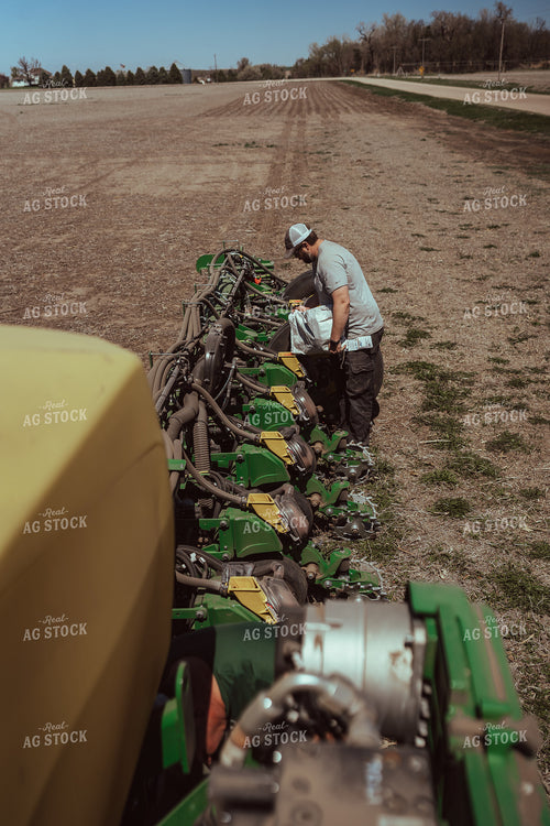Farmer Filling Planter for Test Plot 196137