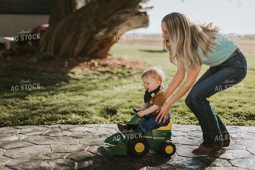Young Boy is Pushed on Toy Combine by Mother 7635