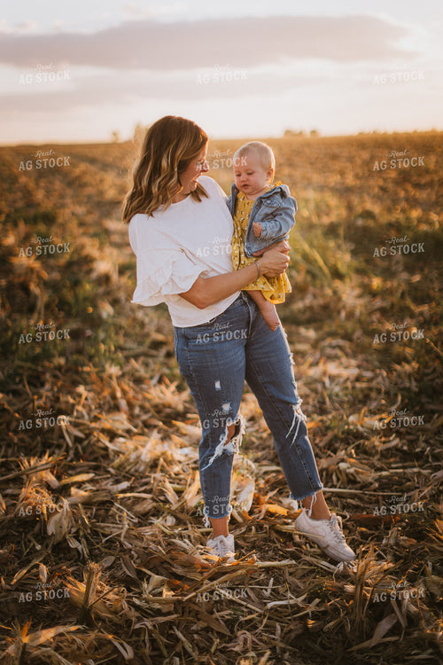 Farm Wife Holding Daughter in Field 9379