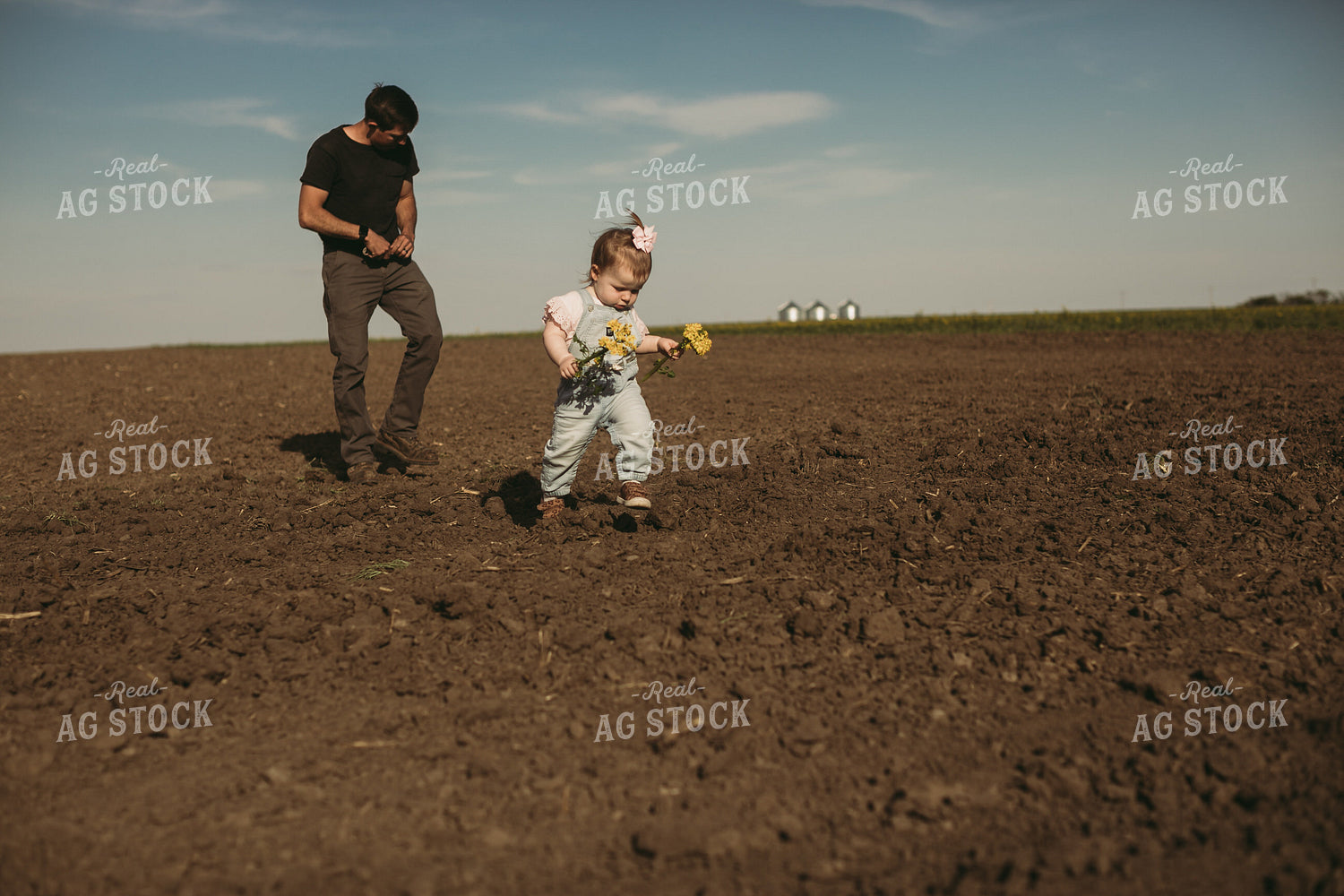 Farmer and Daughter Checking Seed Depth 4179