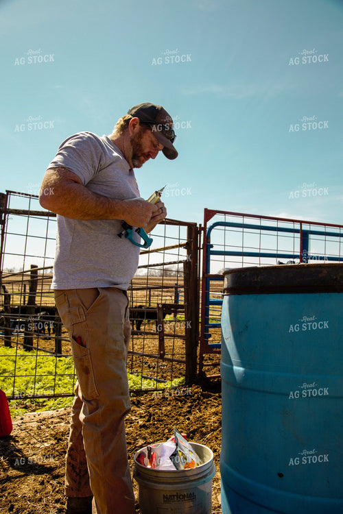 Rancher Prepares Medicine for Cattle 130025