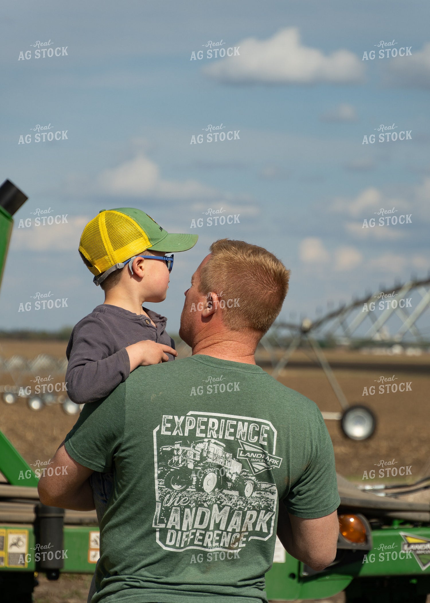 Farmer Holding Son in Field 65418
