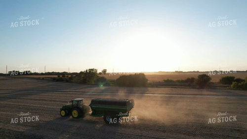 Tractor and Grain Cart Driving Across Field 65921