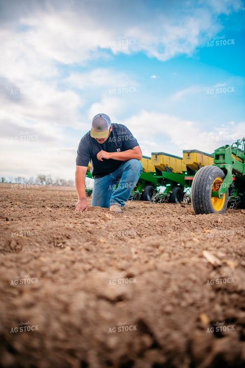 Farmer Checks Seed Depth Behind Planter 56650