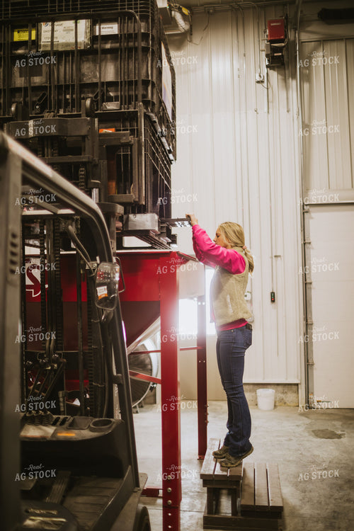 Forklift Operator Emptying Bulk Bin in Seed Warehouse 5349