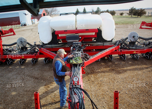 Farmer Fixing Planter 141208