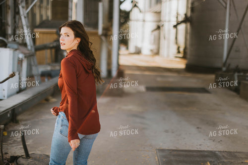 Female Farmer Walking by Grain Bins 8497