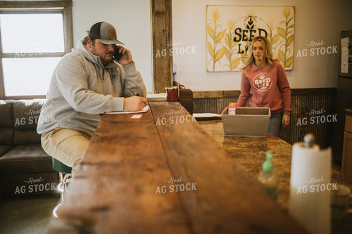 Man Going Over Paperwork and Talking on Phone 5299