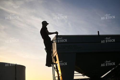 Farmer Climbing up Seed Tender 191011