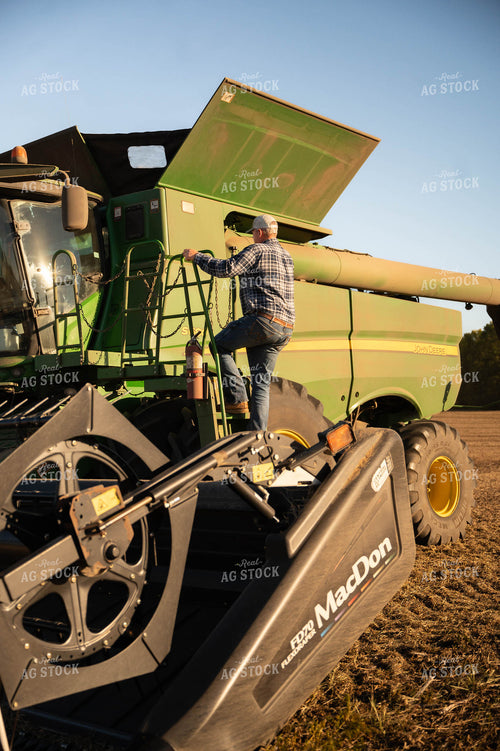 Farmer Climbing into Combine 115429