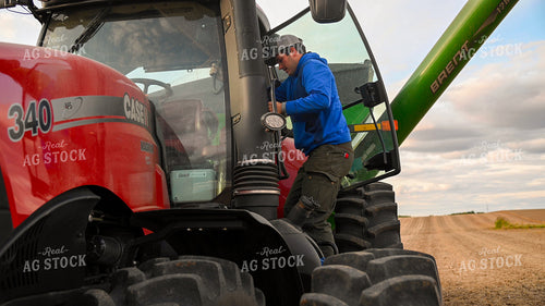 Farmer Climbing into Tractor Cab 25758