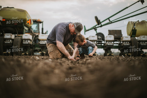 Farmer and Farm Kid Checking Seed Depth 5655