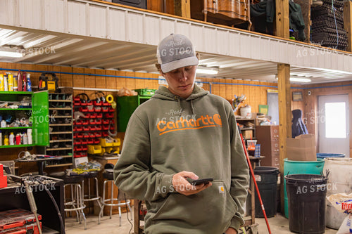 Farmer Using Phone in Shop 231117