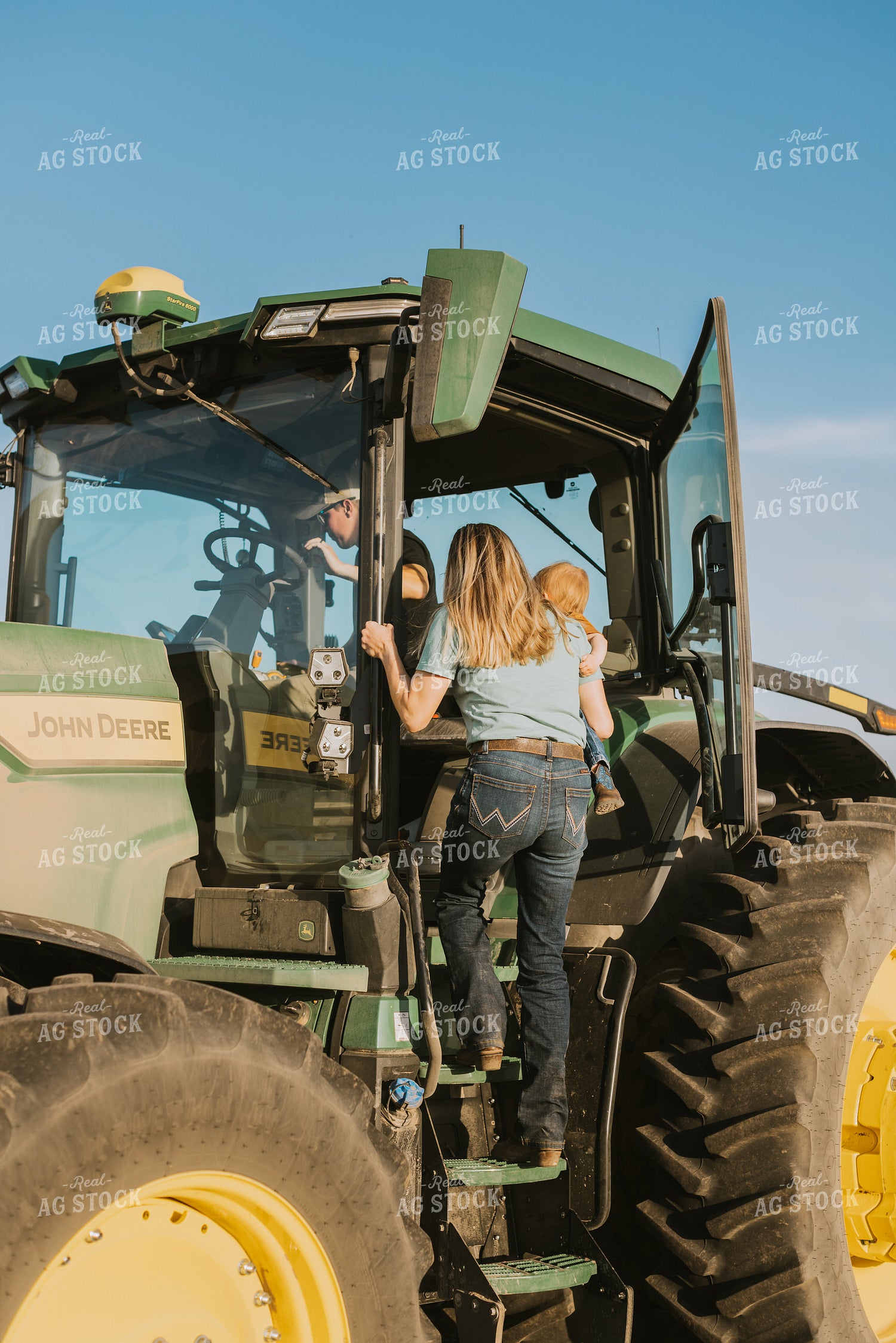 Young Couple with Child Climb in Tractor 7667