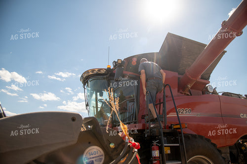 Farmer Climbing into Combine 25886