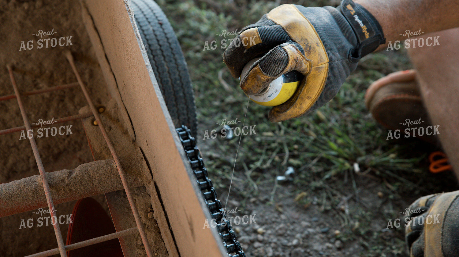Farmer Greasing Sweep Auger 26097