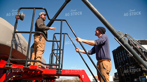 Farmer Loading the Planter with the Seed Tender 25100