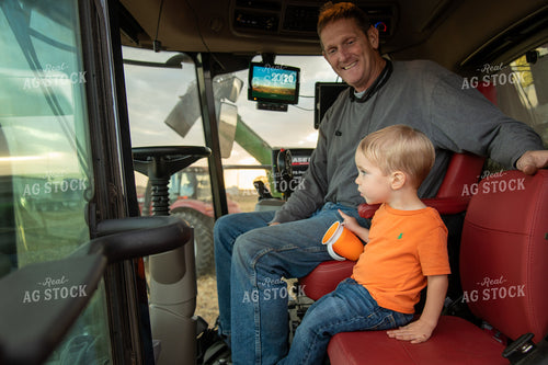 Grandson and Grandfather Farmer in the Combine Cab 25834