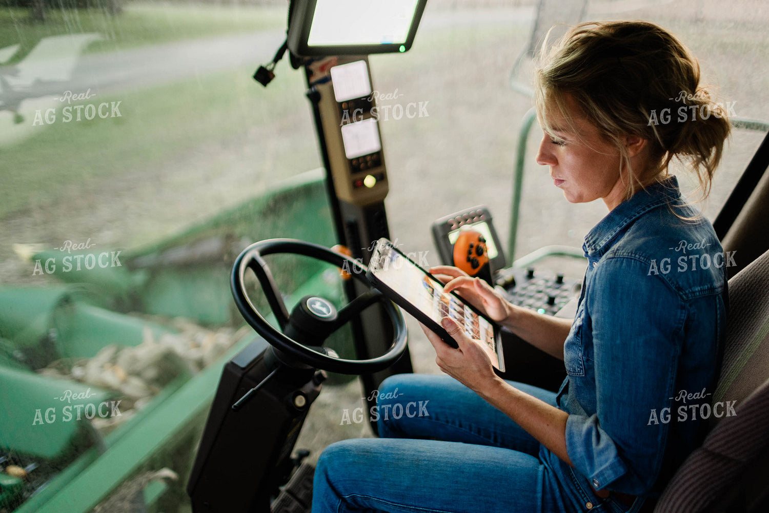 Female Farmer on Tablet in Combine Cab 8397