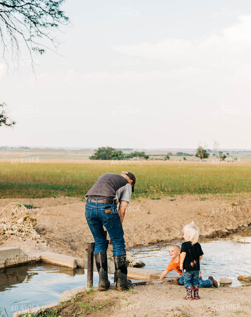Farmer and Farm Kids with Ditch Irrigation 61037
