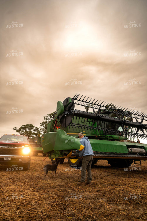 Farmer Fixing Combine Head 115409