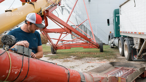 Farmer Operating Sweep Auger 26260