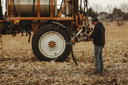 Farmer Checking Sprayer Valves 3642