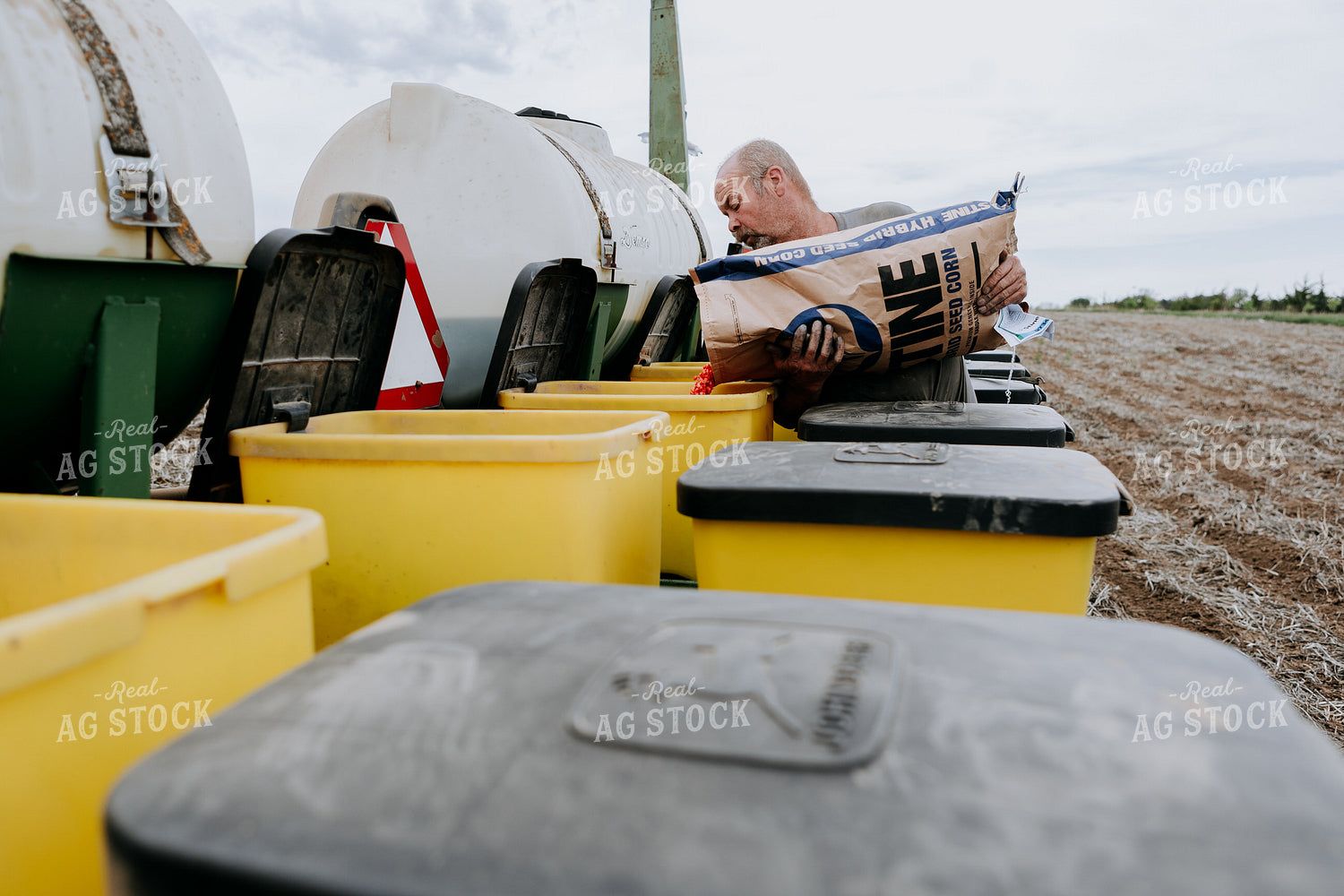 Farmer Filling Planter Boxes 77071