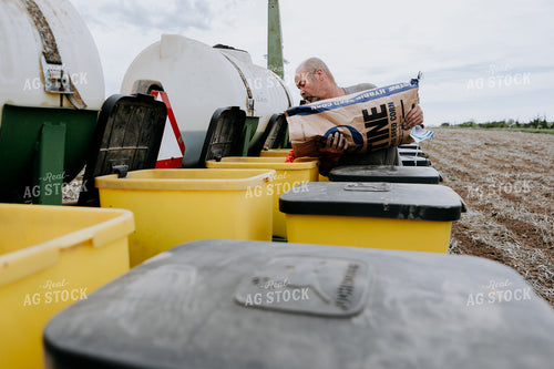 Farmer Filling Planter Boxes 77071