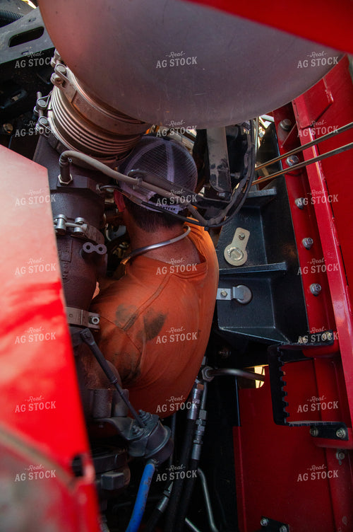 Farmer Repairing Combine 25442